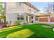 Serene backyard showcasing artificial turf, a covered patio, and well-maintained landscaping for outdoor gatherings at 8528 Sierra Cima Ln, Las Vegas, NV 89128