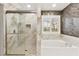 Spa-like bathroom with a glass shower, soaking tub, and mosaic tile accents at 8528 Sierra Cima Ln, Las Vegas, NV 89128