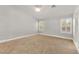 Spacious bedroom with carpet, bright windows, and a modern ceiling fan at 8528 Sierra Cima Ln, Las Vegas, NV 89128