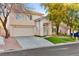 Beautiful two-story home with a well-kept front yard, mature trees, and a double car garage at 8528 Sierra Cima Ln, Las Vegas, NV 89128