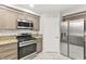 Updated kitchen with stainless steel appliances and granite countertops at 8528 Sierra Cima Ln, Las Vegas, NV 89128