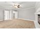 Living room with fireplace, ceiling fan, and multiple doorways at 8528 Sierra Cima Ln, Las Vegas, NV 89128