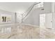 Spacious living area with light gray walls, marble tile floors, and a staircase at 8528 Sierra Cima Ln, Las Vegas, NV 89128