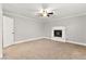 Living room with a cozy fireplace and neutral carpet at 8528 Sierra Cima Ln, Las Vegas, NV 89128
