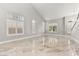 Open-concept living room featuring many windows with plantation shutters and marble floors at 8528 Sierra Cima Ln, Las Vegas, NV 89128