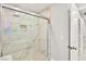 Shower with glass doors, marble interior, rainfall shower head and built in niche at 8528 Sierra Cima Ln, Las Vegas, NV 89128
