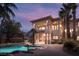 An estate home featuring a pool, lush landscaping, a large patio, and a balcony for enjoying the outdoors at 9904 Moonridge Ct, Las Vegas, NV 89134