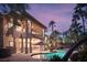 Expansive backyard with a pristine pool, covered patio, balcony, and beautifully manicured landscaping, perfect for entertaining at 9904 Moonridge Ct, Las Vegas, NV 89134