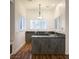 Stylish bar area featuring custom cabinets, granite countertop, wood floors and natural light at 9904 Moonridge Ct, Las Vegas, NV 89134