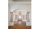 Elegant foyer features wood floors, chandelier, arched entryway, columns, and view to the double door entry at 9904 Moonridge Ct, Las Vegas, NV 89134
