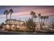 Beautiful home with a grand entrance, lush landscaping, and towering palm trees lining the front yard at 9904 Moonridge Ct, Las Vegas, NV 89134