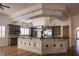 Spacious kitchen with an island, granite countertops, stainless appliances, and wood floors at 9904 Moonridge Ct, Las Vegas, NV 89134