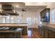 Kitchen area with granite countertops, wood cabinets, stainless appliances, and shutters at 9904 Moonridge Ct, Las Vegas, NV 89134