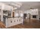 Spacious kitchen and living area with wood floors, an island, granite countertops, and stainless appliances at 9904 Moonridge Ct, Las Vegas, NV 89134