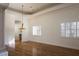 Open living room features wood floors, natural light, trey ceilings, plantation shutters and view to hall at 9904 Moonridge Ct, Las Vegas, NV 89134