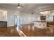 Bright open-concept living room featuring wood floors and a view to the bar, kitchen and the backyard at 9904 Moonridge Ct, Las Vegas, NV 89134