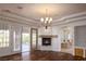 Bedroom with fireplace, balcony access, and ensuite bath featuring columns at 9904 Moonridge Ct, Las Vegas, NV 89134