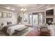 Main bedroom featuring a fireplace, balcony access, and warm, inviting design at 9904 Moonridge Ct, Las Vegas, NV 89134