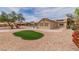 This backyard features a covered patio with a BBQ and artificial grass at , Las Vegas, NV 89134