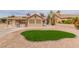 Beautiful backyard with green artificial turf and concrete patio at , Las Vegas, NV 89134