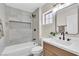 Bathroom with tiled shower over tub, modern fixtures, and window at , Las Vegas, NV 89134