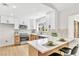 Well-lit kitchen boasts quartz counters, stainless appliances, tile backsplash, and breakfast bar at , Las Vegas, NV 89134
