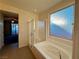 Bathroom featuring a tub, shower, and large window with natural light at 10145 White Mulberry Dr, Las Vegas, NV 89148