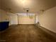 Spacious garage with a functional garage door and ample storage space for vehicles and tools at 10145 White Mulberry Dr, Las Vegas, NV 89148