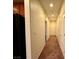 Hallway leading to bedrooms featuring neutral paint and carpet flooring at 10145 White Mulberry Dr, Las Vegas, NV 89148