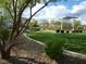 A view of the community park, featuring grassy areas, landscaping, and a shaded structure at 10145 White Mulberry Dr, Las Vegas, NV 89148