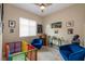 Bedroom featuring a ceiling fan, pictures on the wall, and blue velvet chairs at 10943 Doresta Ave, Las Vegas, NV 89166