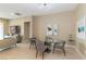 Dining area with glass table, modern chairs, and view of the living room at 10943 Doresta Ave, Las Vegas, NV 89166