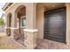 Stylish arched doorway and modern front door with stone pillar accents at 10943 Doresta Ave, Las Vegas, NV 89166