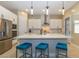Open kitchen with a large island, white countertops, and stainless steel appliances at 10943 Doresta Ave, Las Vegas, NV 89166