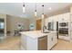 Modern kitchen featuring an island, stainless steel appliances, and sleek white cabinetry at 10943 Doresta Ave, Las Vegas, NV 89166