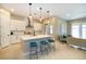 Open kitchen with a large island, white cabinets, and adjacent living area at 10943 Doresta Ave, Las Vegas, NV 89166