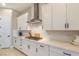 Kitchen with white countertops and cabinets, tile backsplash, and stainless steel vent hood at 10943 Doresta Ave, Las Vegas, NV 89166