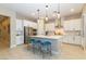 Modern kitchen featuring a large island, white cabinets, and stainless steel appliances at 10943 Doresta Ave, Las Vegas, NV 89166