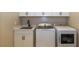 Laundry room with modern washer and dryer next to stainless steel sink at 10943 Doresta Ave, Las Vegas, NV 89166