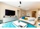 Living room with TV, modern furniture, and access to the dining area and kitchen at 10943 Doresta Ave, Las Vegas, NV 89166