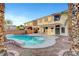 The backyard features a serene pool, patio, and lush landscaping for a relaxing outdoor space at 10965 Ladyburn Ct, Las Vegas, NV 89141