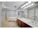 Bright bathroom featuring double sinks, separate tub and shower with tile flooring at 10965 Ladyburn Ct, Las Vegas, NV 89141