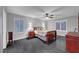 Bedroom with dark floors, gray walls, ceiling fan, and window at 10965 Ladyburn Ct, Las Vegas, NV 89141