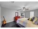 Bedroom with dark floors, gray walls, ceiling fan, window and dresser at 10965 Ladyburn Ct, Las Vegas, NV 89141