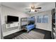Bedroom featuring a bunk bed, ceiling fan, and a wall-mounted television at 10965 Ladyburn Ct, Las Vegas, NV 89141