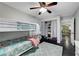 Bedroom featuring a bunk bed, ceiling fan, closet, and gray wood-look floors at 10965 Ladyburn Ct, Las Vegas, NV 89141