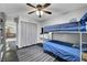 Bedroom featuring a bunk bed, ceiling fan, and gray wood-look floors at 10965 Ladyburn Ct, Las Vegas, NV 89141