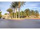 Elegant gated community entrance with lush landscaping and towering palm trees welcomes residents and guests alike at 10965 Ladyburn Ct, Las Vegas, NV 89141