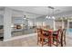 Open concept dining area adjacent to the kitchen and living room with natural light and views of the pool at 10965 Ladyburn Ct, Las Vegas, NV 89141