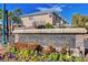 Stone community sign with colorful flowers welcoming residents and guests at 10965 Ladyburn Ct, Las Vegas, NV 89141
